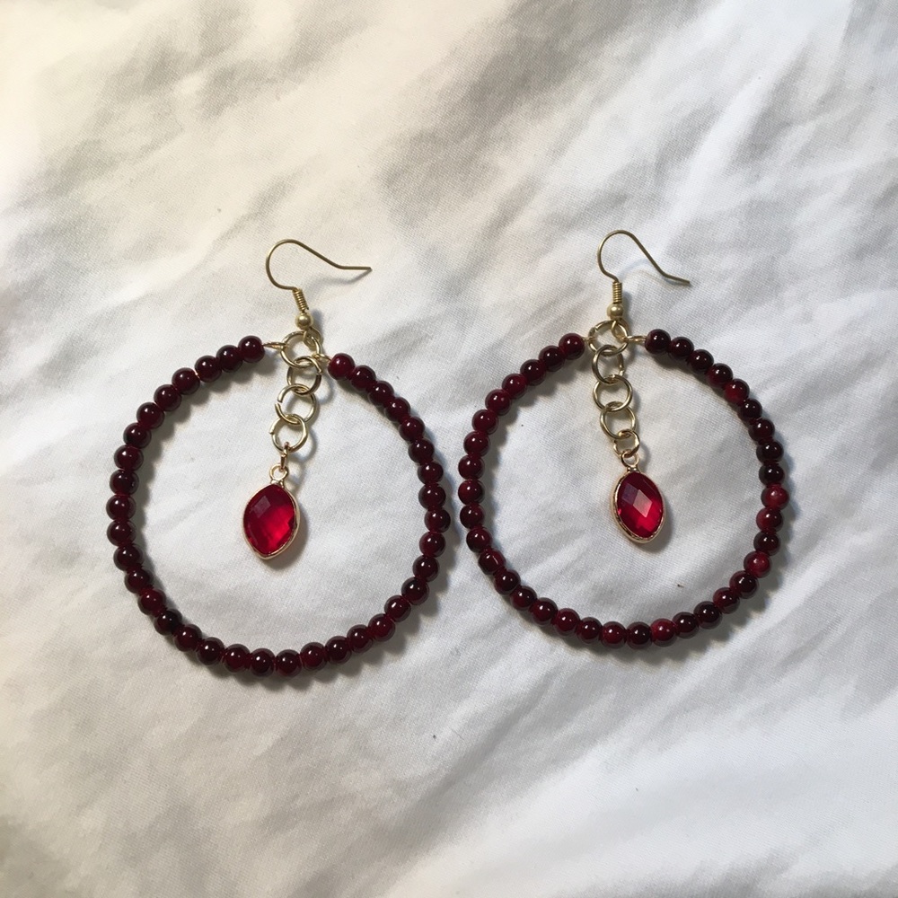 Red hoop earrings with charm